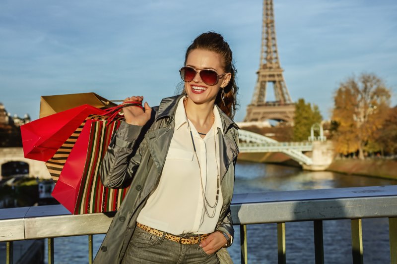 woman in sunglasses with shopping bags