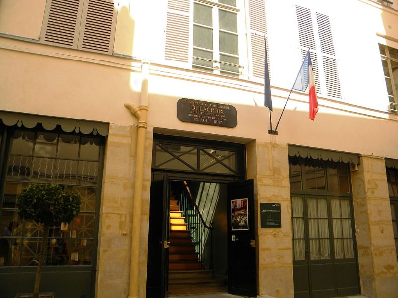 The door of Museum Delacroix with a sign and two flags