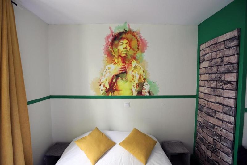 Single Room with one bed and an aesthetic wall art at Absolute Paris Hostel