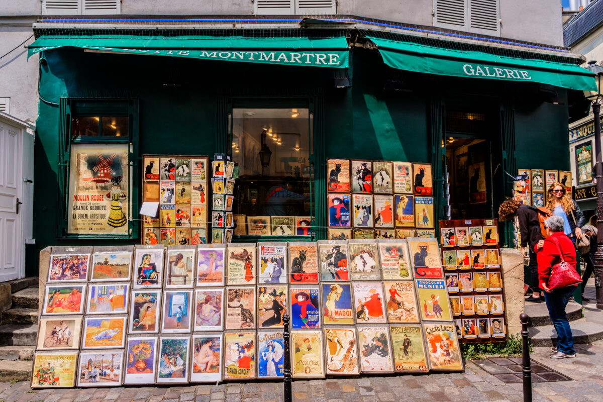 Old art prints for sale in Montmartre gallery. Charming streets of Montmartre hill are full of art galleries, cafes and shops - one of most visited landmarks in Paris.