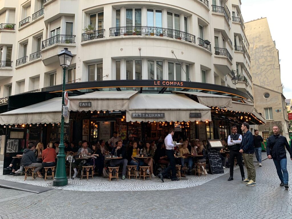 Rue Montorgueil is a lively street in Paris, France, bustling with a vibrant mix of bars and cafés, perfectly capturing the essence of Parisian life.