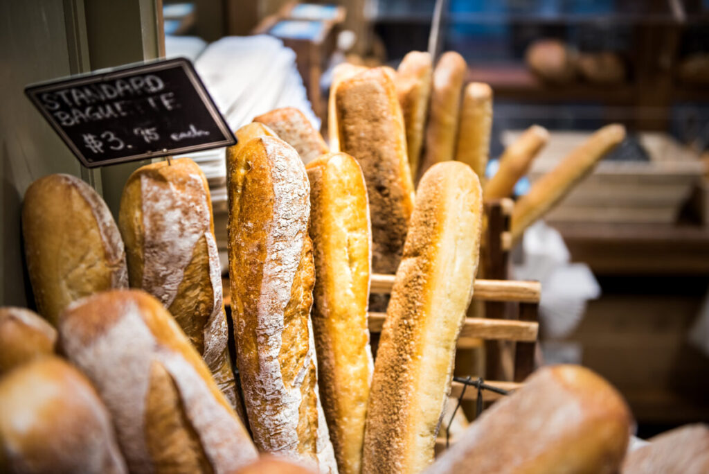 Closeup of fresh golden standard baked baguette loaves in bakery basket