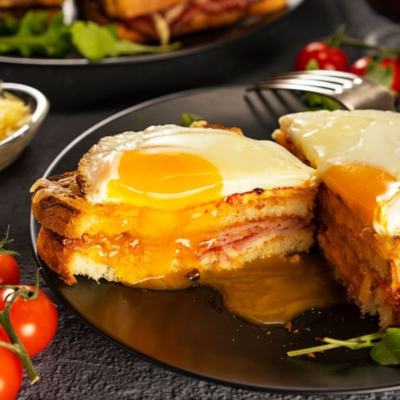 Toast with cheese and ham with half-cooked egg