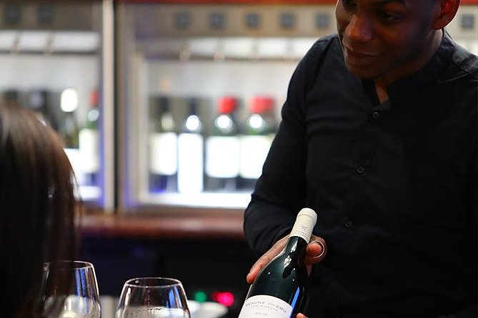 Champagne Tasting for Two in Paris with a wine bottle being served.