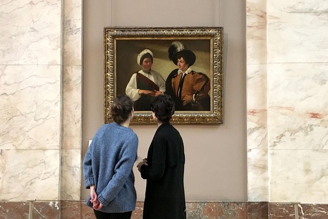 Discover the secrets of the Louvre with tourists viewing the various paintings.