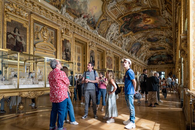 Louvre Museum Semi-Private Skip the Line Guided Tour featuring tourists appreciating the work of art in the musuem.