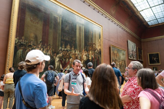 Louvre Museum Semi-Private Skip the Line Guided Tour featuring tourists appreciating the work of art in the musuem.