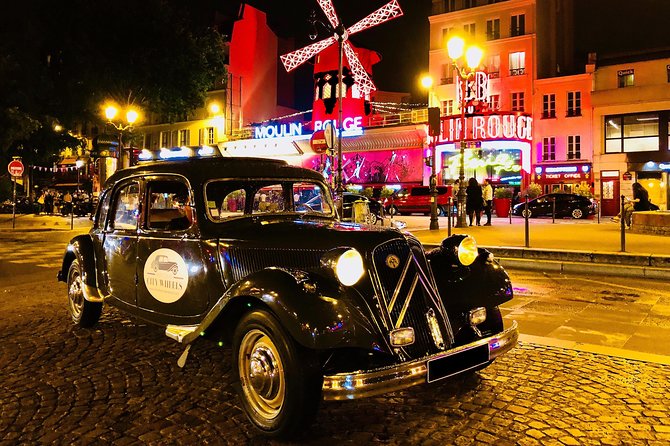 Paris by Night 2h Tour in Vintage French Car in front Moulin Rouge as one of the most iconic landmarks and hidden gems under the stars.