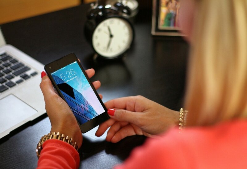 Woman checking the time on her phone