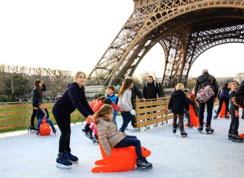 A family group skating at the famous Eiffel Tower in Paris France