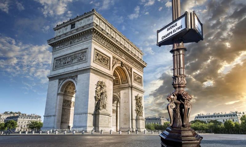 A sunset view photo of the Arc de Triomphe