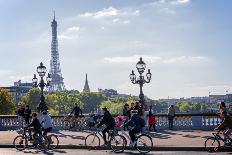 bikers on a bridge beside eiffel tower