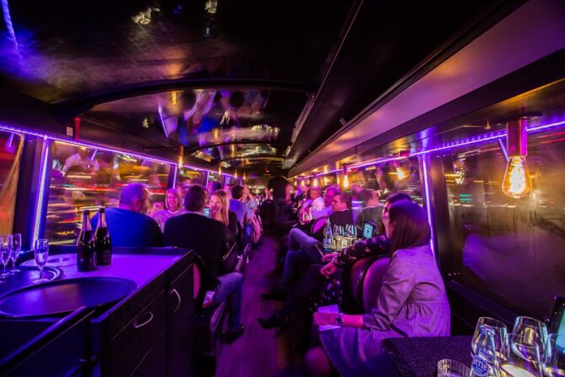 People Dining Inside A Bus During A Night Tour