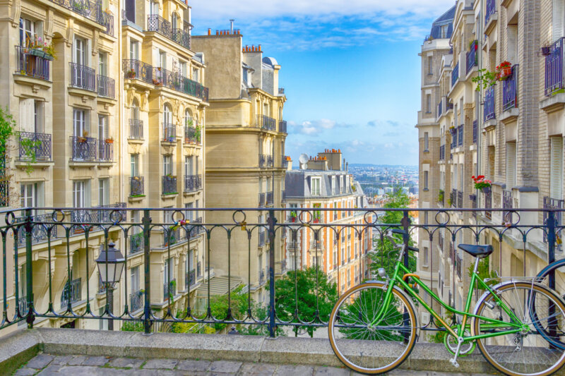 View on old street and district Montmartre in Paris with bicycle is parked, France