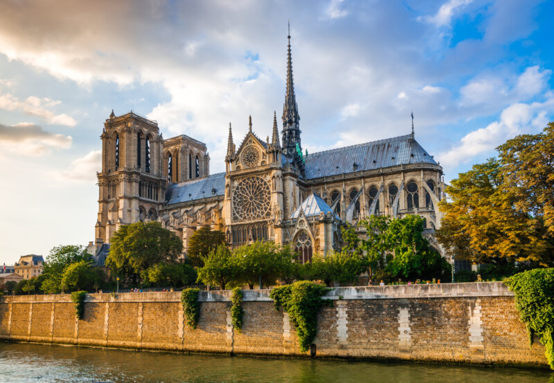 Gorgeous sunset over Notre Dame cathedral with puffy clouds, Paris, France