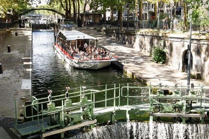 a boat cruising on the Canal Saint Martin