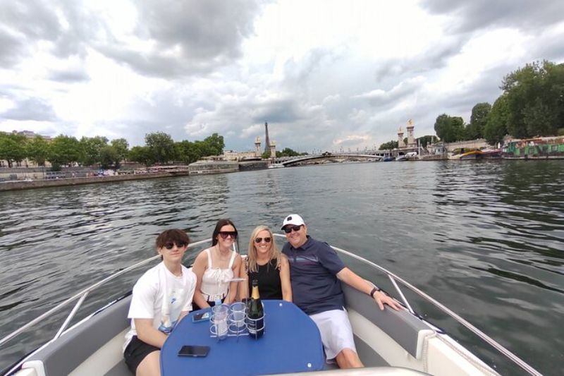 a family enjoying a boat tour in Paris