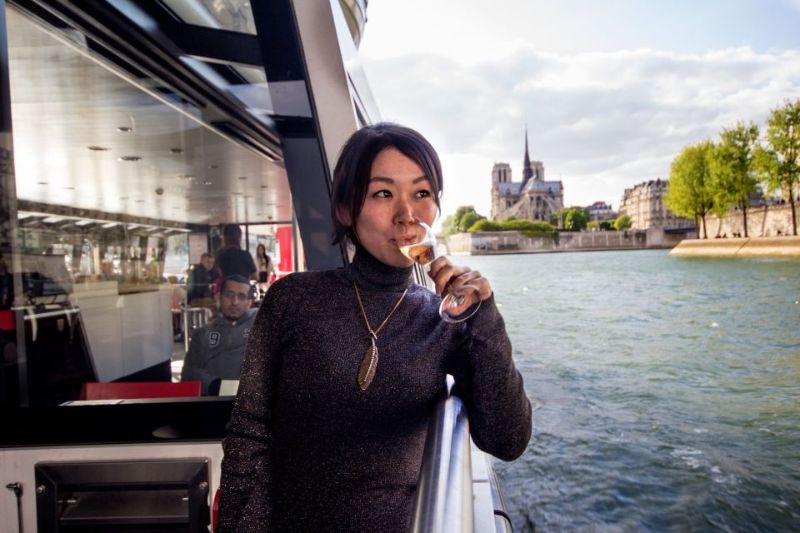 a girl tourist enjoying a glass of wine on a boat cruise