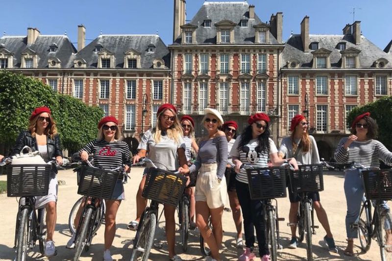 a group of girl tourists in their bikes posing for a photo