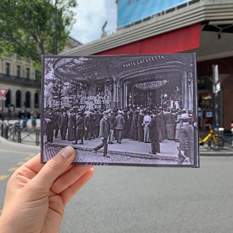 a person's hand holding a black and white photo of Galeries Lafayette