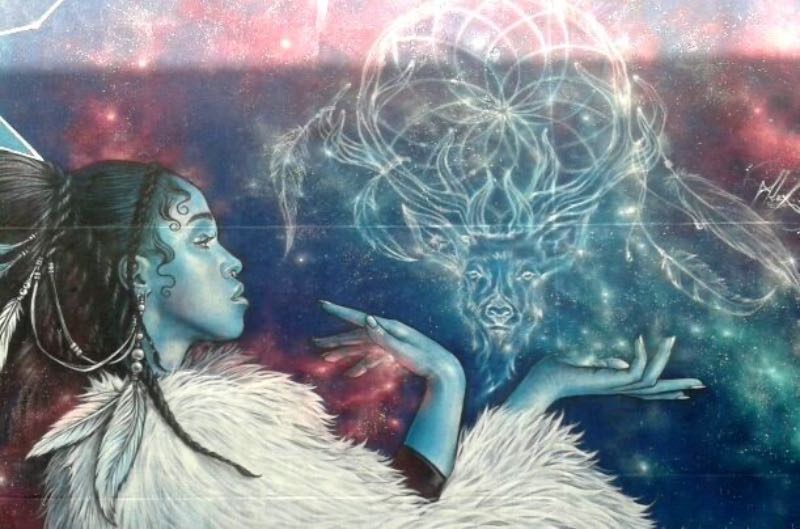 a street art painting of a blue girl
