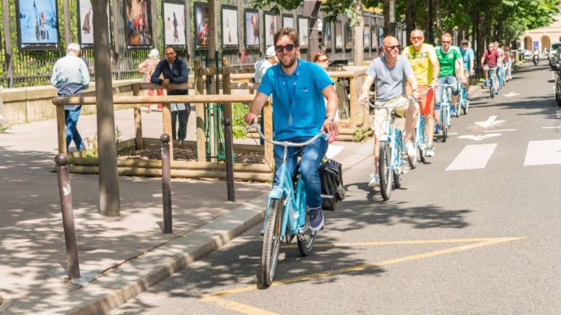 group of tourists biking around the Paris neighborhood