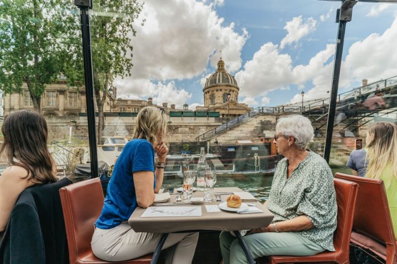 people enjoying lunch on a glass see-through boat tour