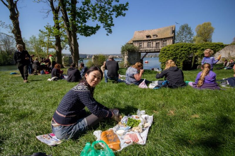 people on a picnic at the grass overlooking the sea