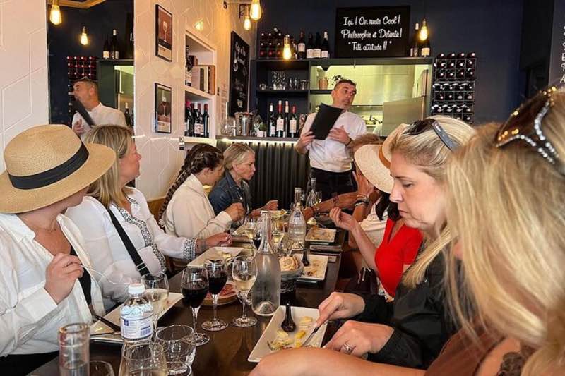 tourists enjoying wine tasting and French pastries