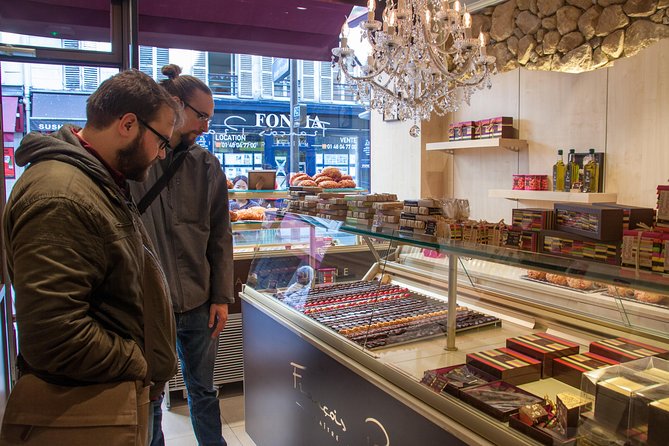 Two men watching chocolates in Paris