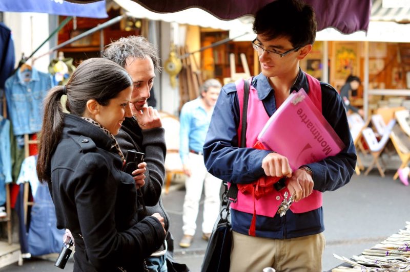 a private guide and tourists exploring Parisian markets