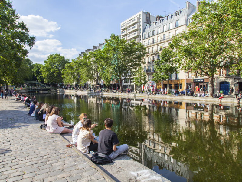 Tourists and locals sitting in front of Saint Martin canal