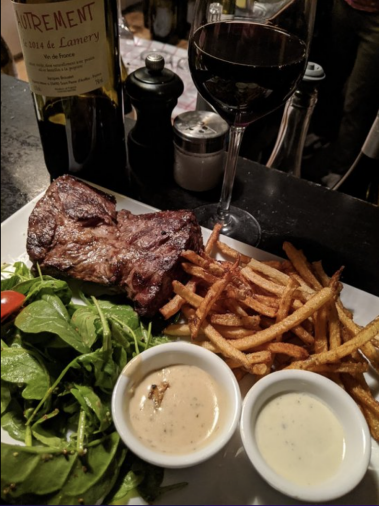 steak, salad, and fries with wine at l'aller retour

