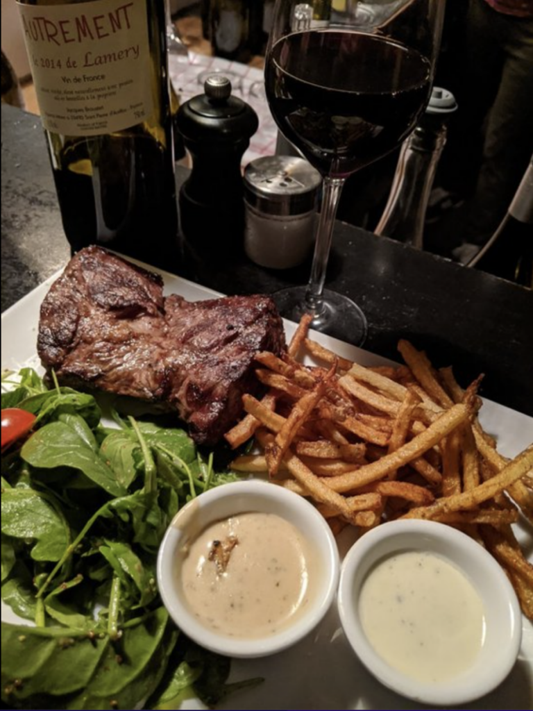 steak, salad, and fries with wine at l'aller retour