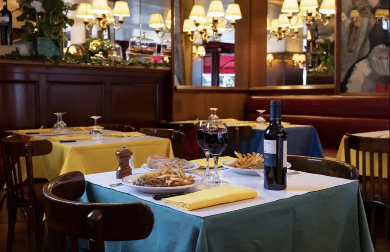 fries and red wine at a table in le relais de l'entrecote