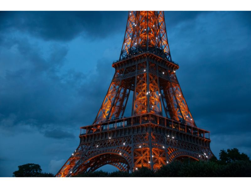 Eiffel Tower glowing at dusk in the city of Paris