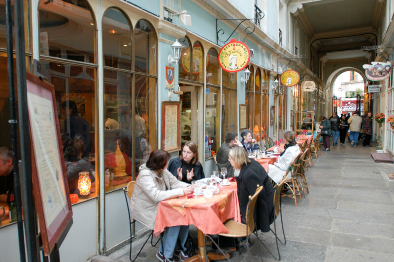 People eating and drinking in a street restaurant of Paris on France