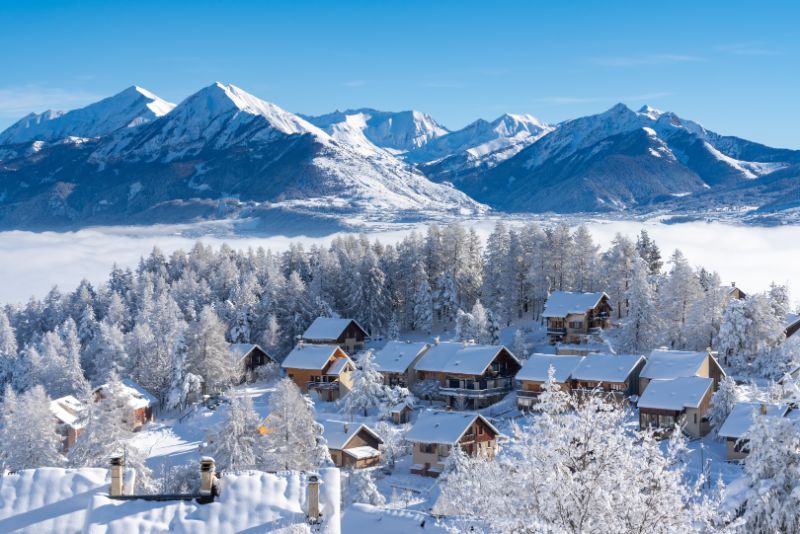 Fresh snow covers roofs and trees of Laye winter ski resort in French Alps