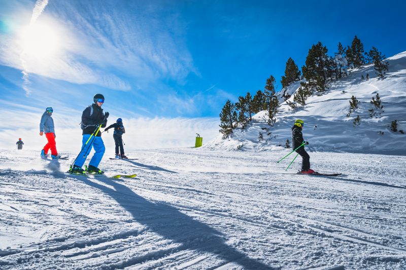 Group of people skiing and snowboarding in the Alps