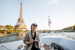 Young woman enjoying beautiful landscape view on the riverside with Eiffel tower