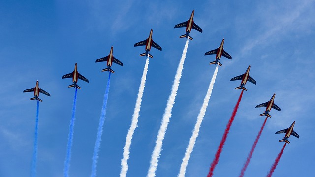 Flyover of military aircraft featuring the colors of the French flag