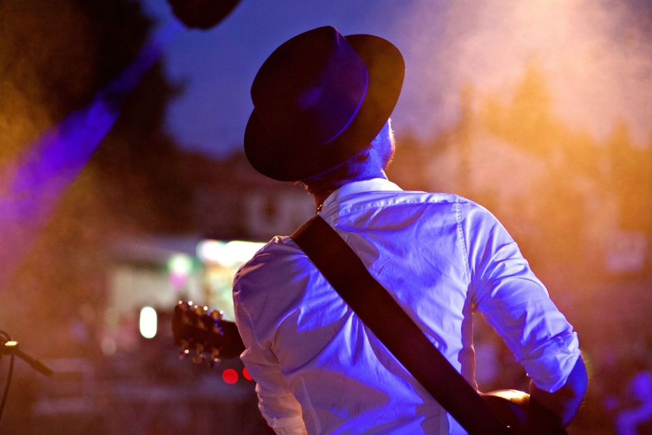 Back view of a man with a guitar