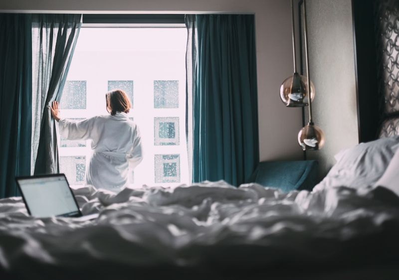 Woman in white robe in a hotel in Paris