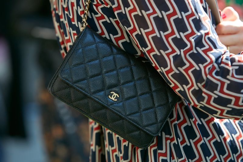 Woman with small Chanel black leather bag