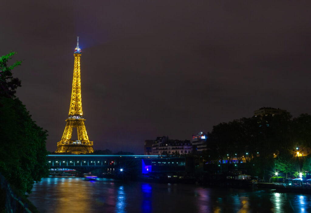 A picture of the illuminated Eiffel Tower at night.