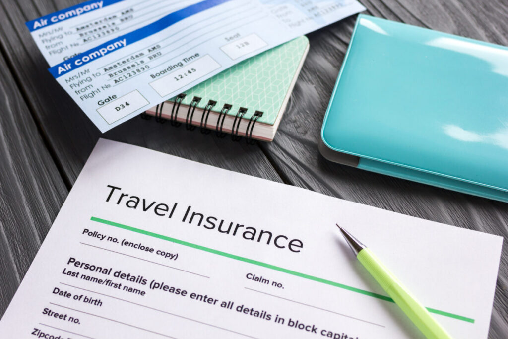 Travel insurance application form on wooden desk background
