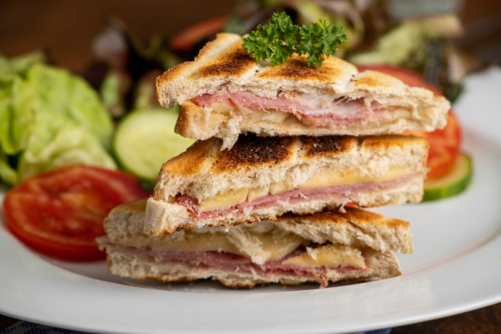 french croque monsieur prepared on a wooden board