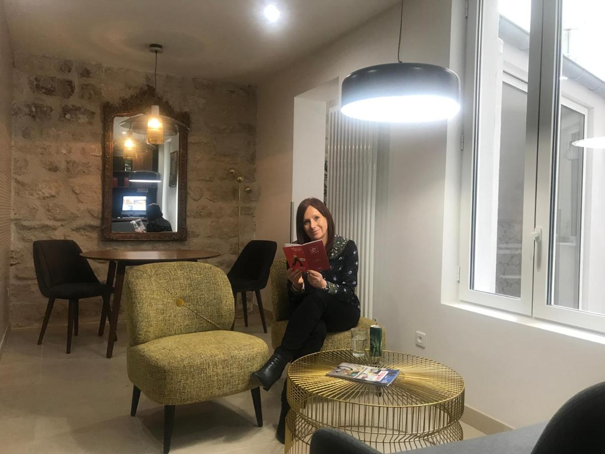 Hôtel De Venise with a woman reading a book in the lobby