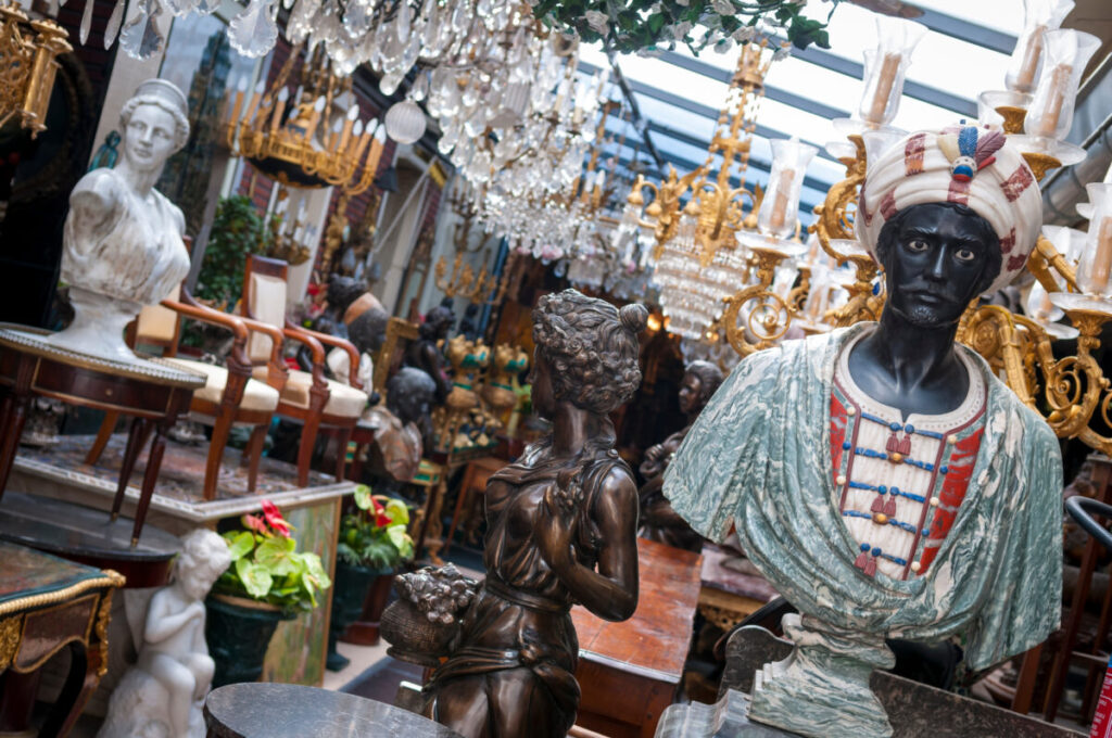 View of eclectic flea market crowded with vintage secondhand goods in Paris, France