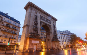 Porte Saint-Denis monument lit up at twilight, Paris.